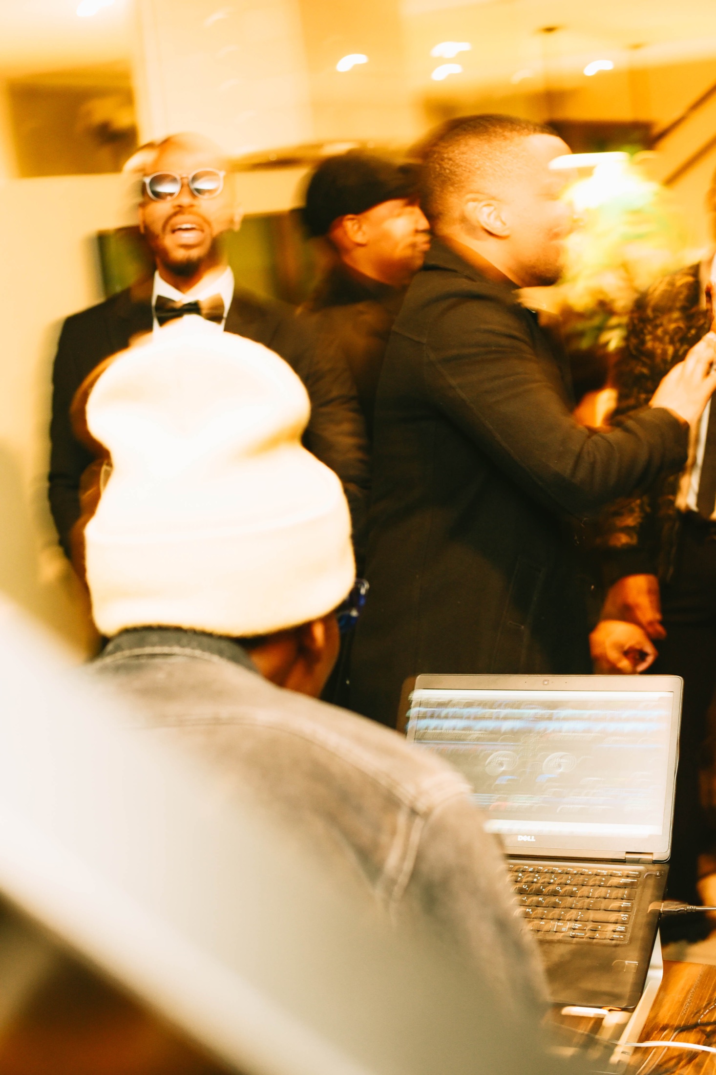 Warm-toned event room with the DJ setup centred.